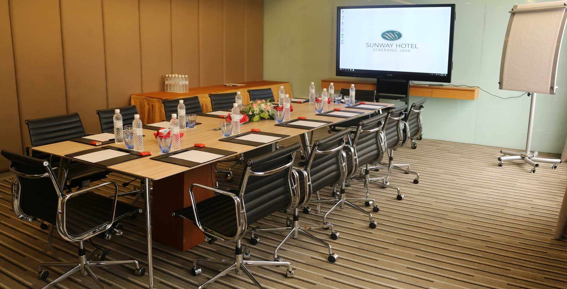 Boardroom meeting room arranged with a TV and chairs at Sunway Hotel Seberang Jaya