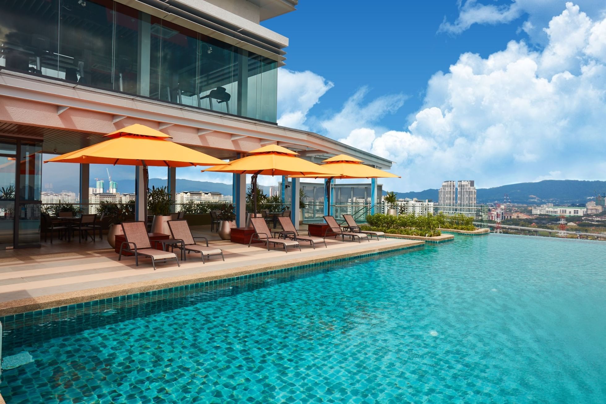 Infinity swimming pool at Sunway Velocity Hotel with deck chairs