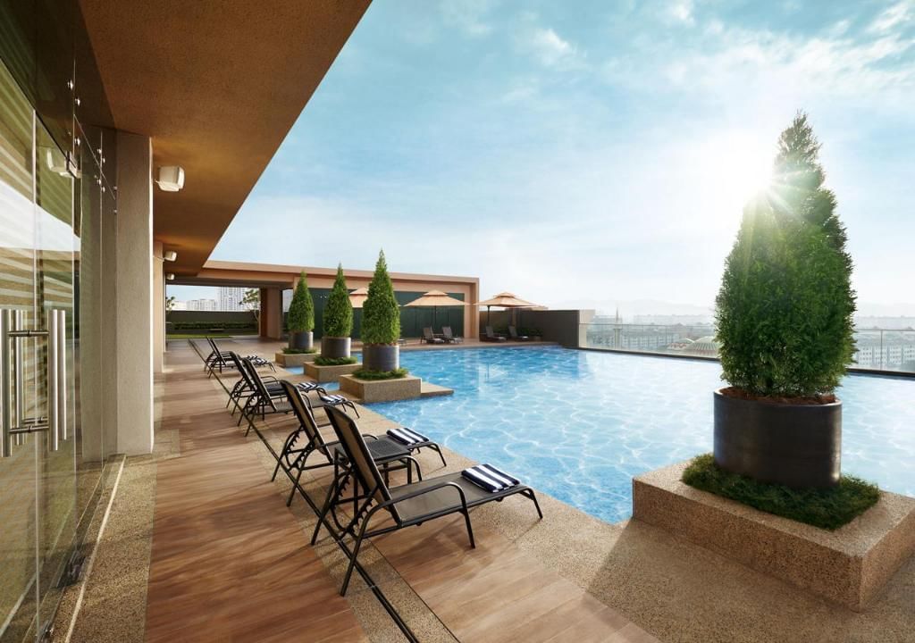 Exterior infinity pool with a sunbed area at Sunway Lagoon