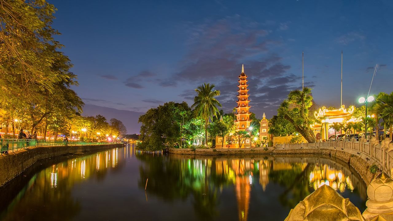 Distance exterior of Tran Quoc Pagoda with a lake at night near Sunway Hotel Hanoi