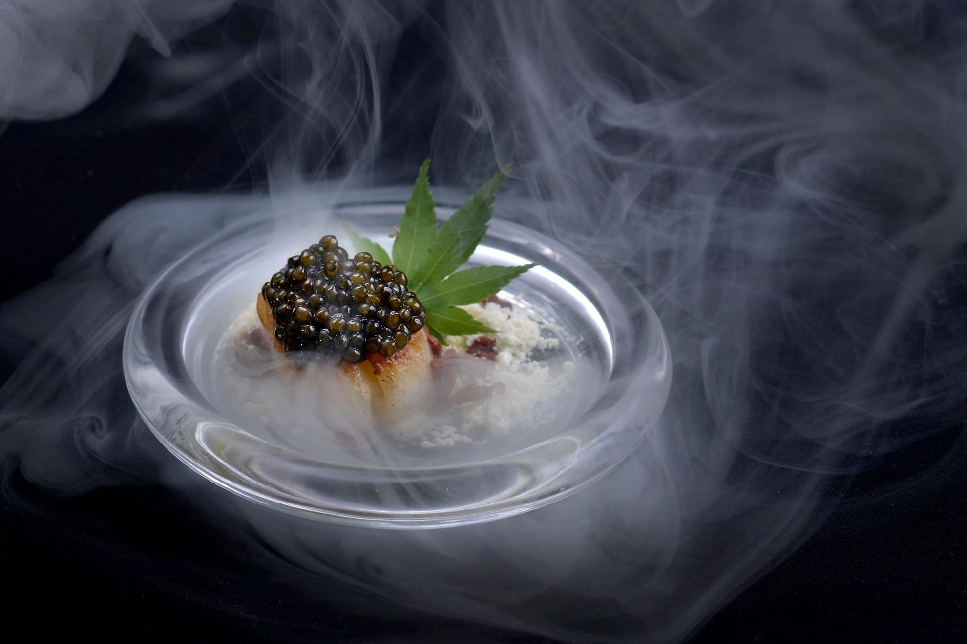 Close-up a caviar inspired dish presented with smoke at The Banjaran Hotsprings Retreat