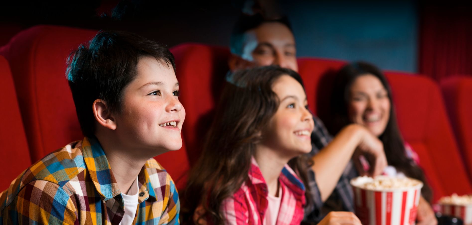 Family watching a movie in a theater near Sunway Hotel Pyramid