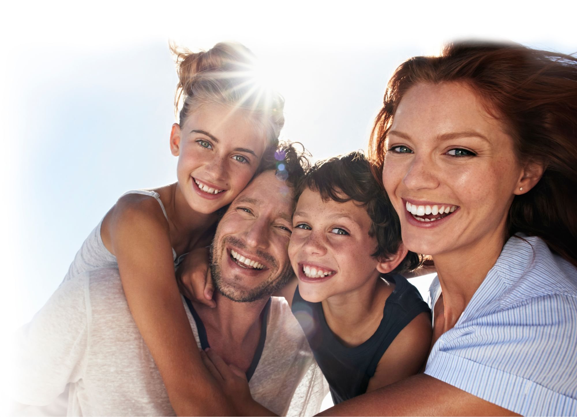 A family hugging and posing for a photo in outside at Sunway Hotels & Resorts
