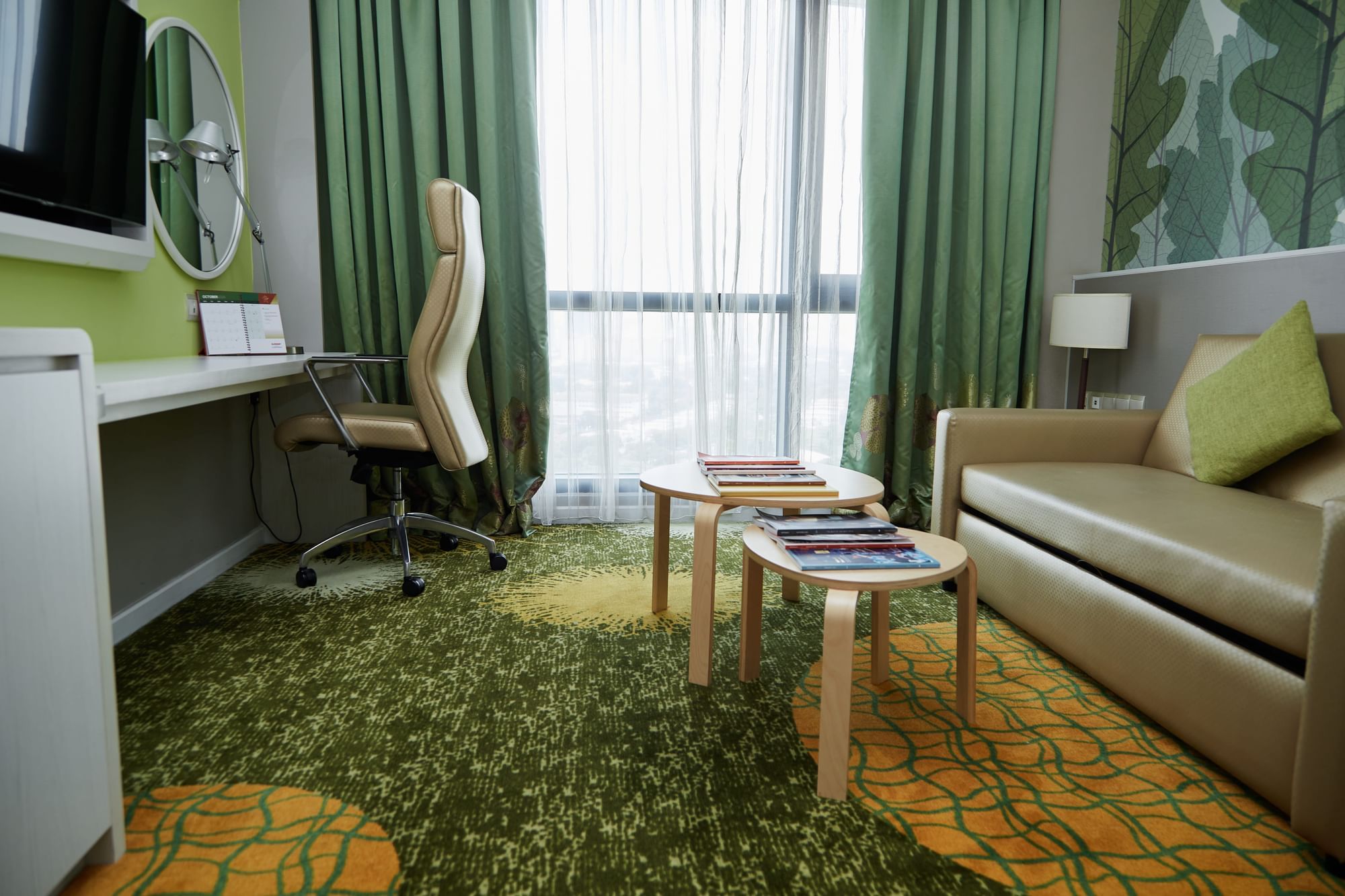 TV longe with sofa and work desk by the window in Deluxe Twin Room at Sunway Velocity Hotel