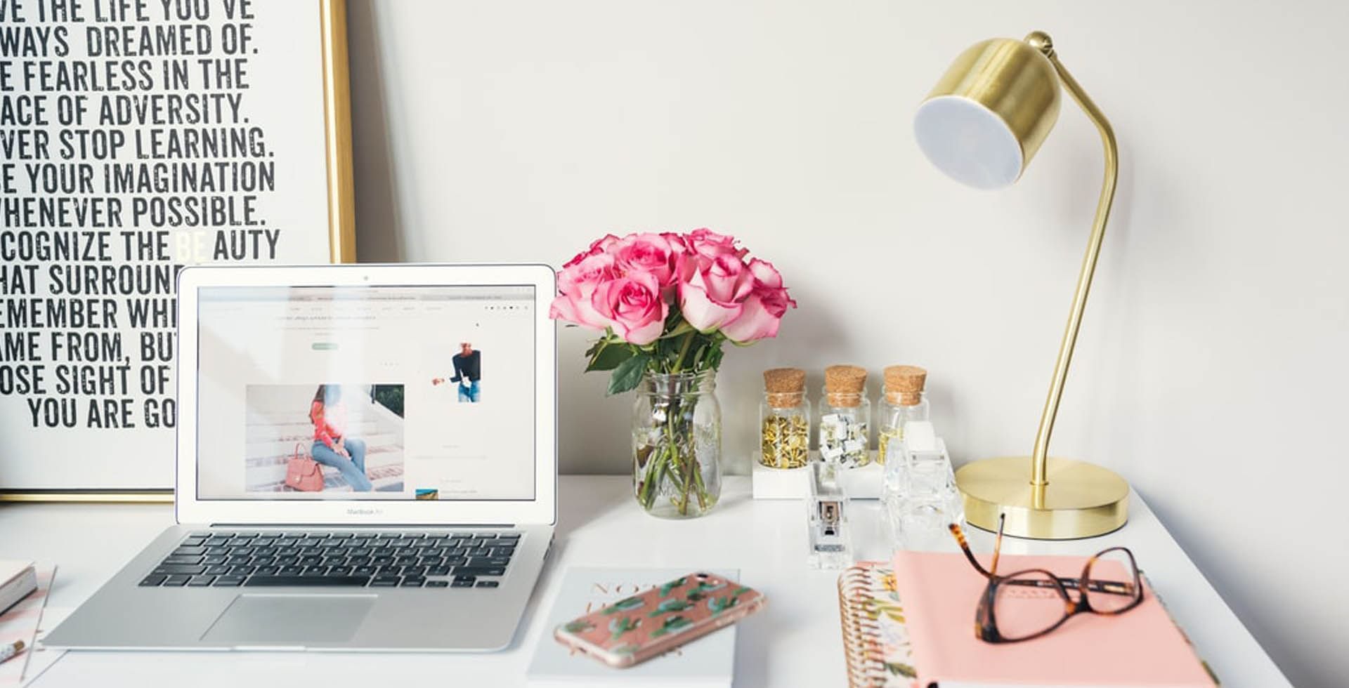 Workspace area with a laptop, table lamp, glasses, and a flower vase at Sunway Hotel Seberang Jaya