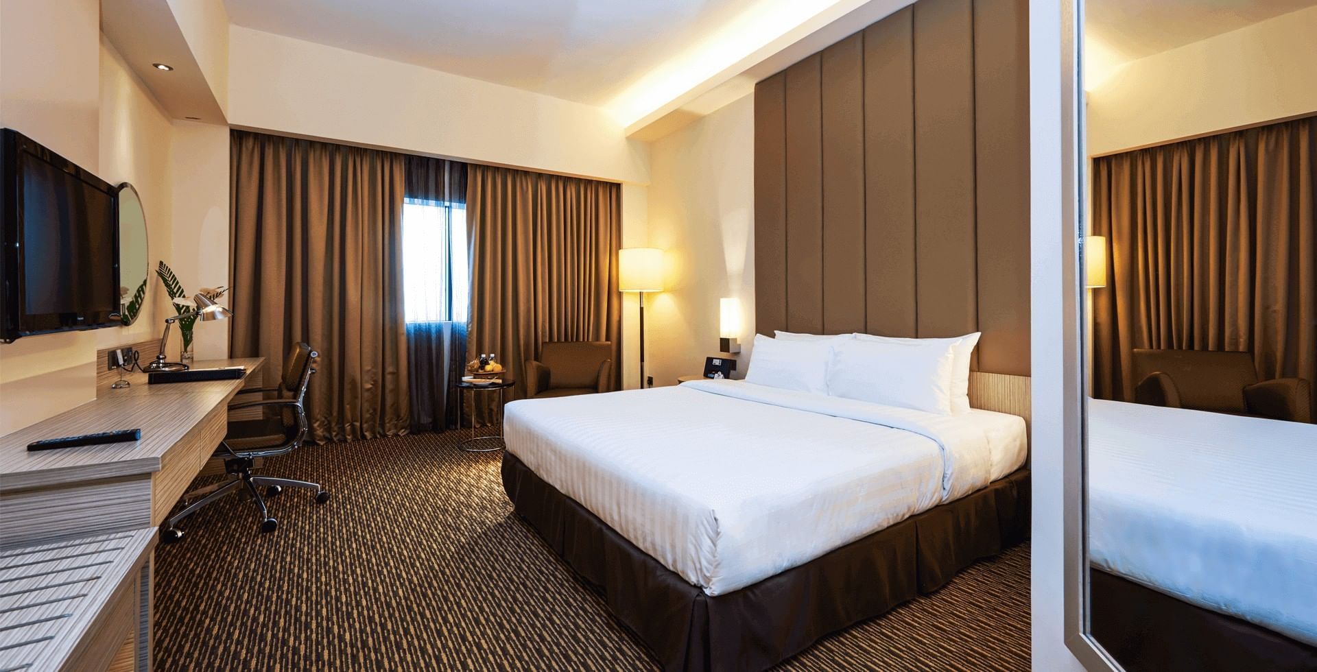 King-size bed, workspace & a TV in Deluxe King Room at Sunway Hotel Seberang Jaya
