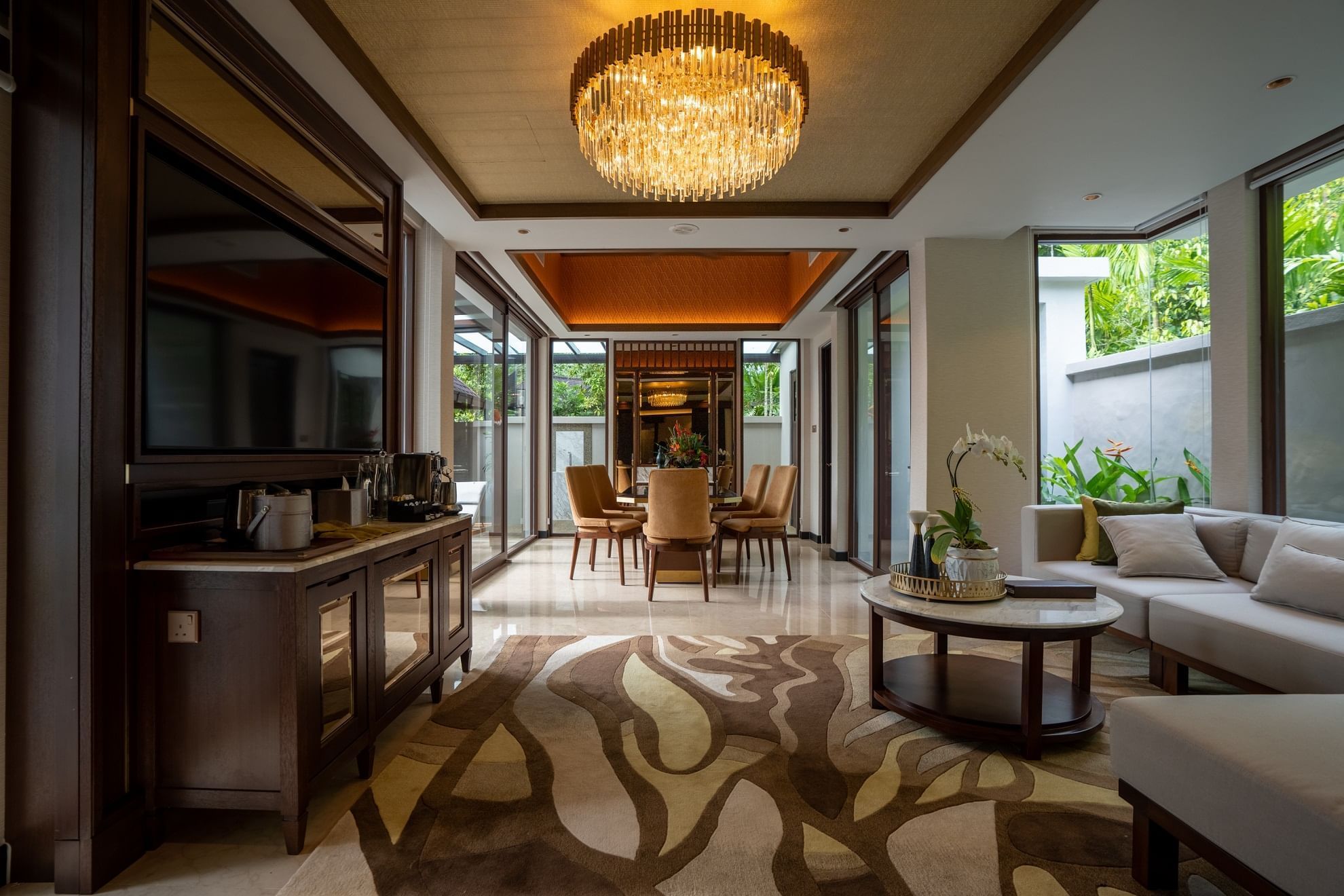 Lounge area with a TV stand in a Villa at The Banjaran Hotsprings Retreat