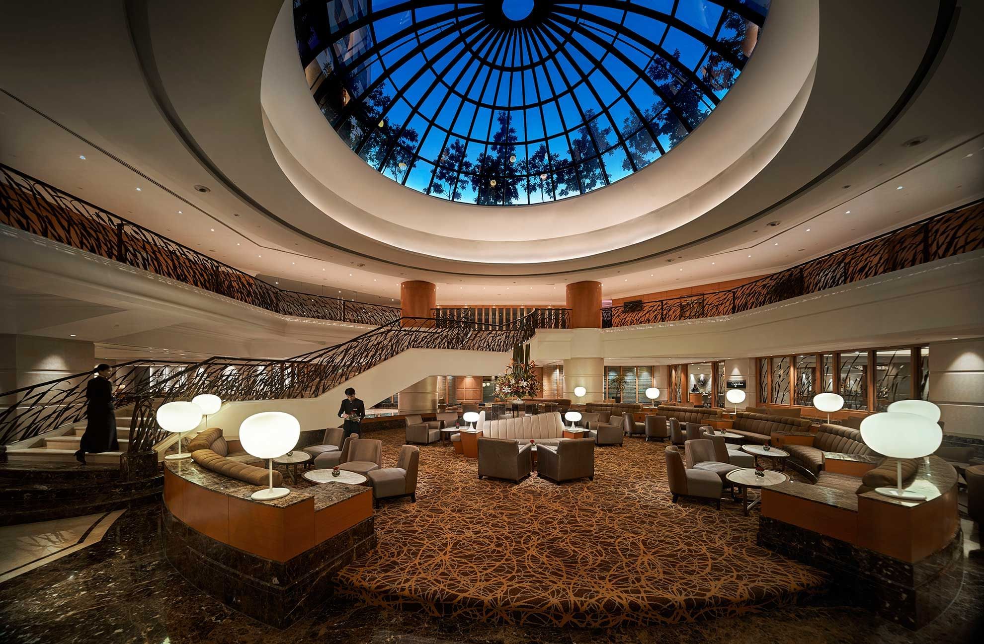 Elegant lobby with circular skylight, staircase and seating at Sunway Hotels & Resorts