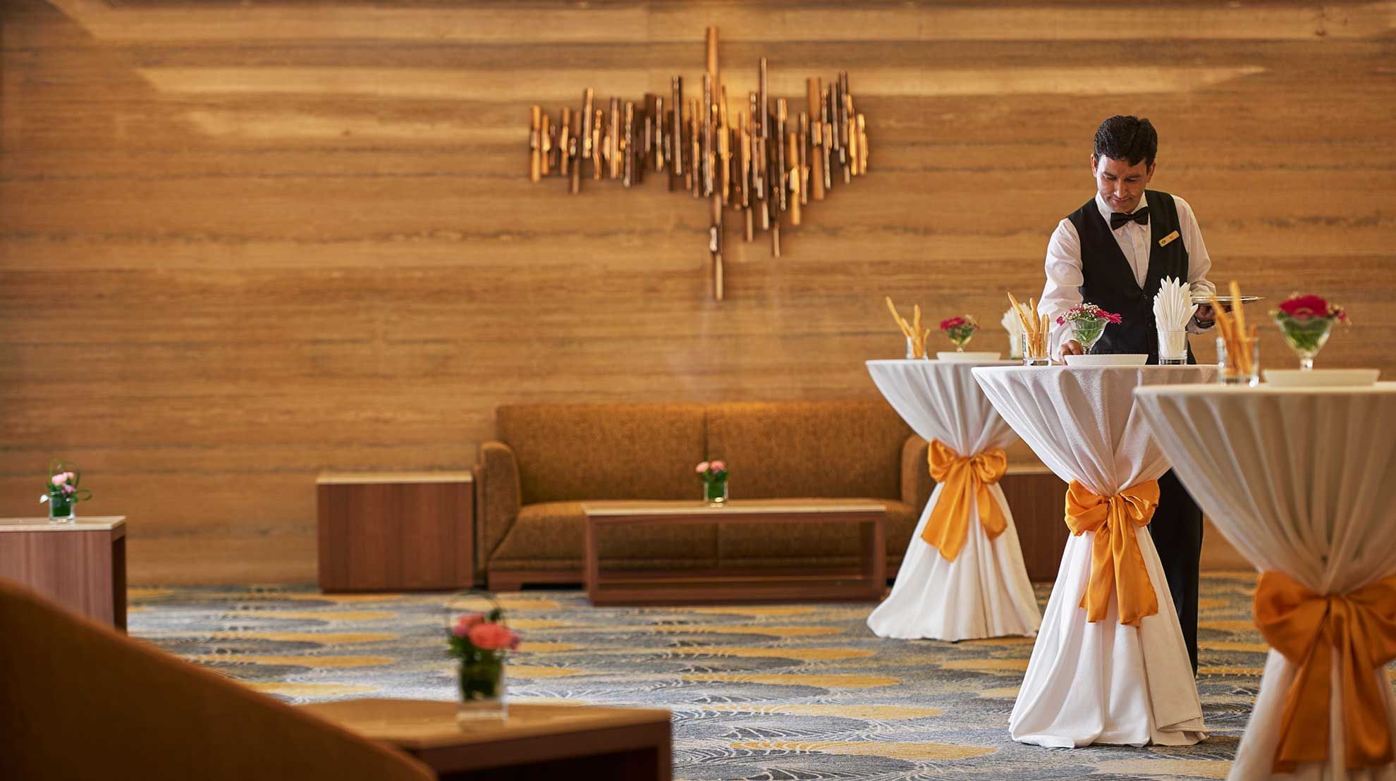 Waiter arranging a cocktail set-up for an event at Sunway Putra Hotel