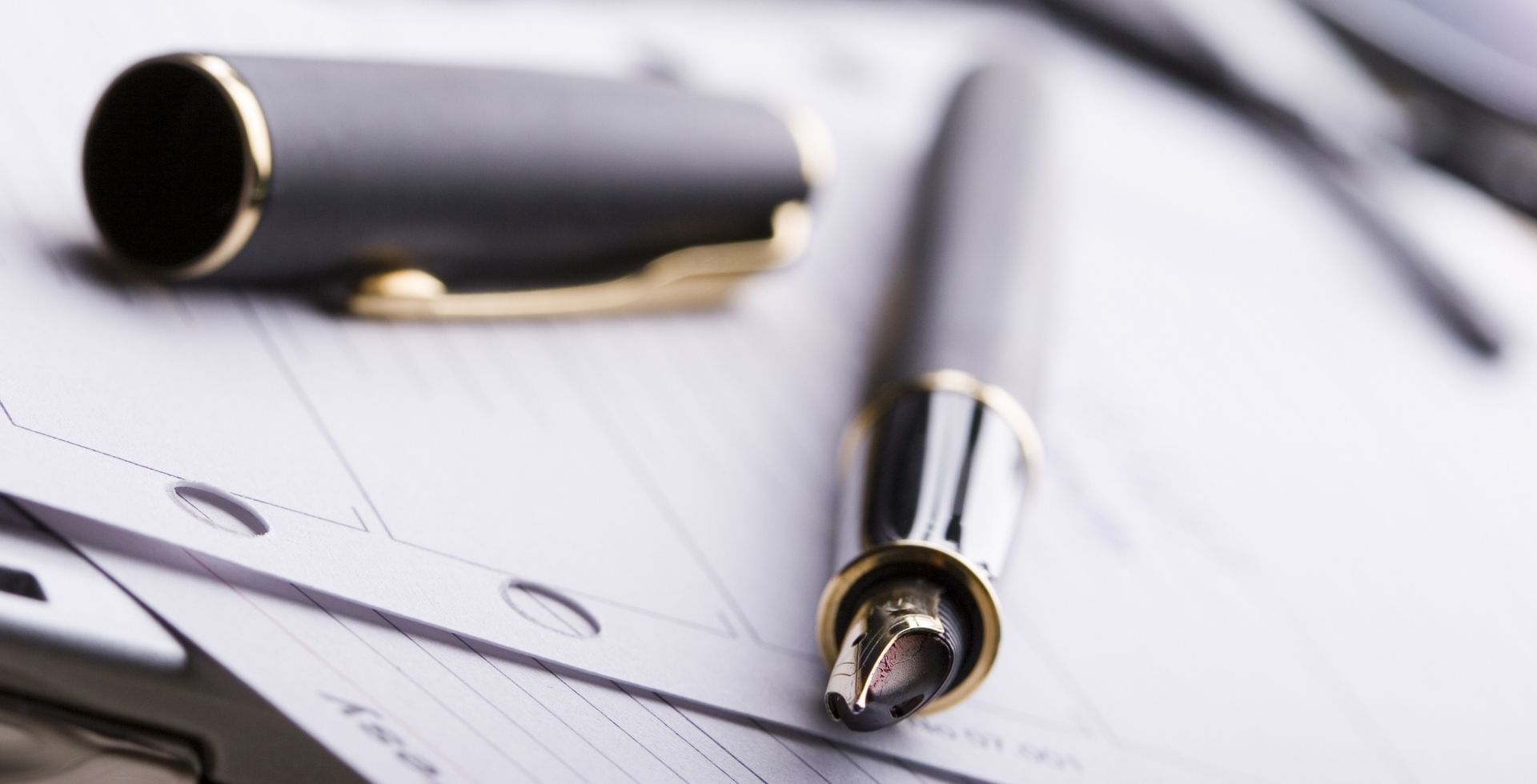 Close-up of an elegant pen on blurred papers at Sunway Hotel Big Box