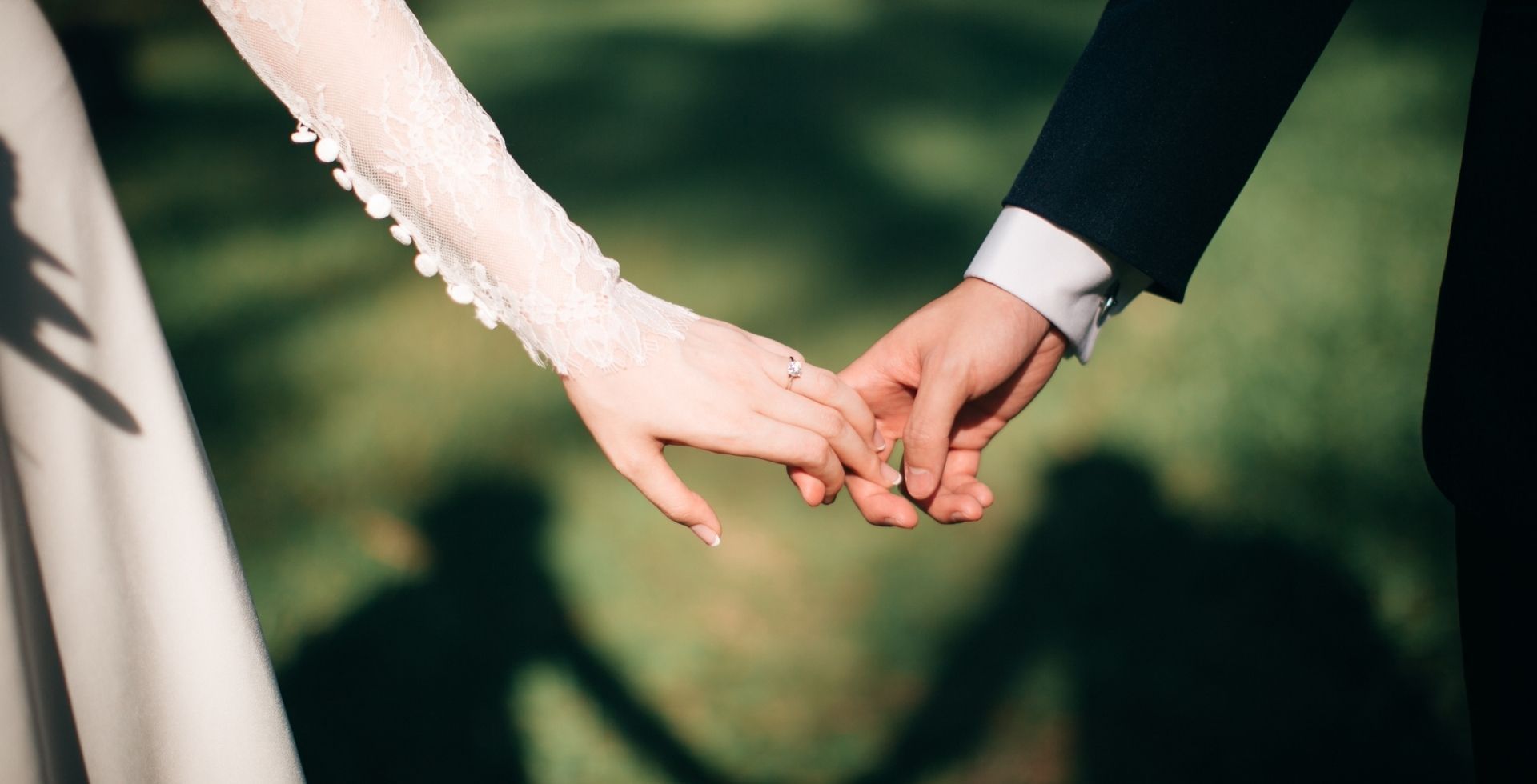 Wedded couple holding hands on the lawn at Sunway Hotel Big Box