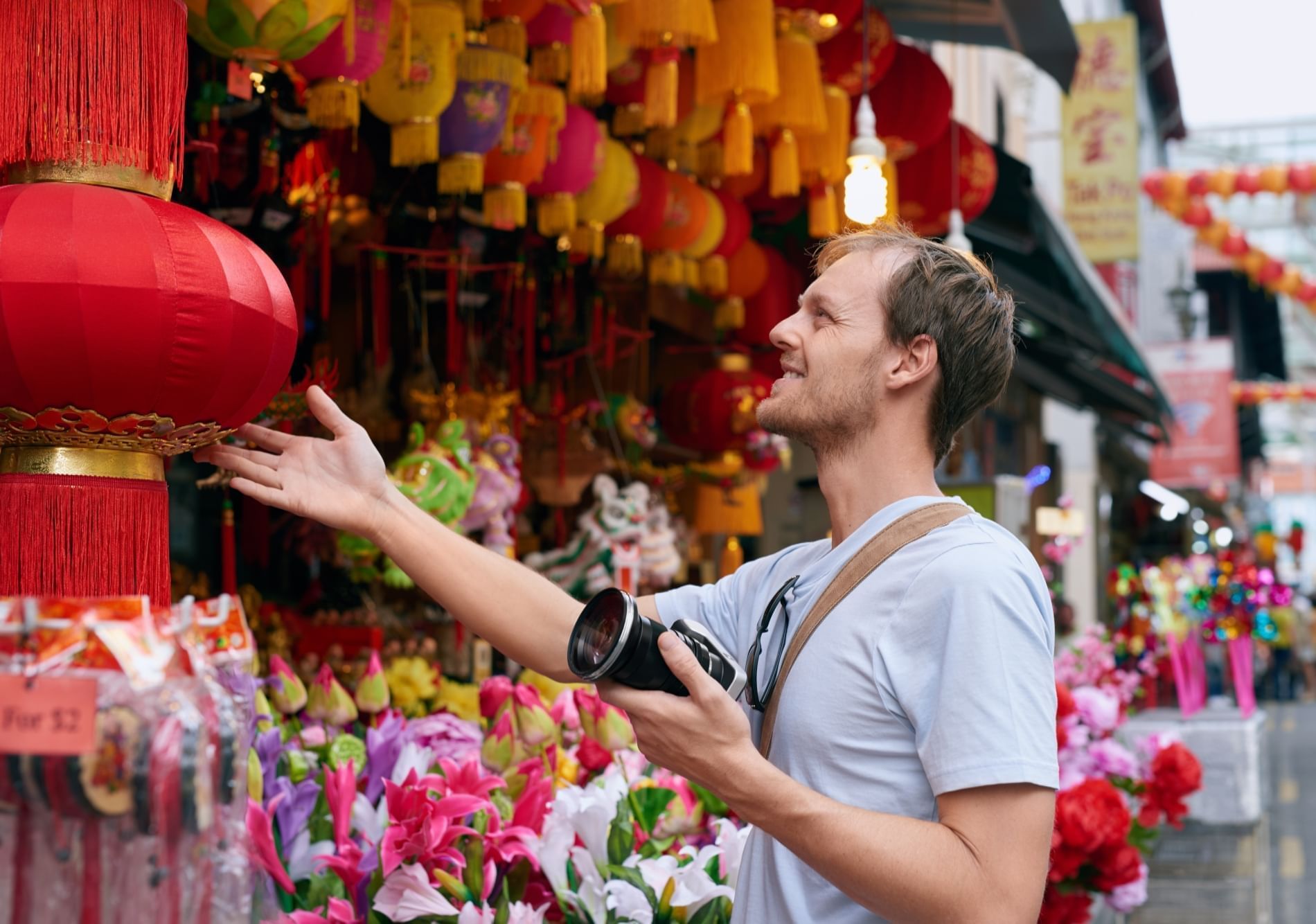 Man admiring souvenirs at the Jalan Petaling Chinatown shop near Sunway Velocity Hotel