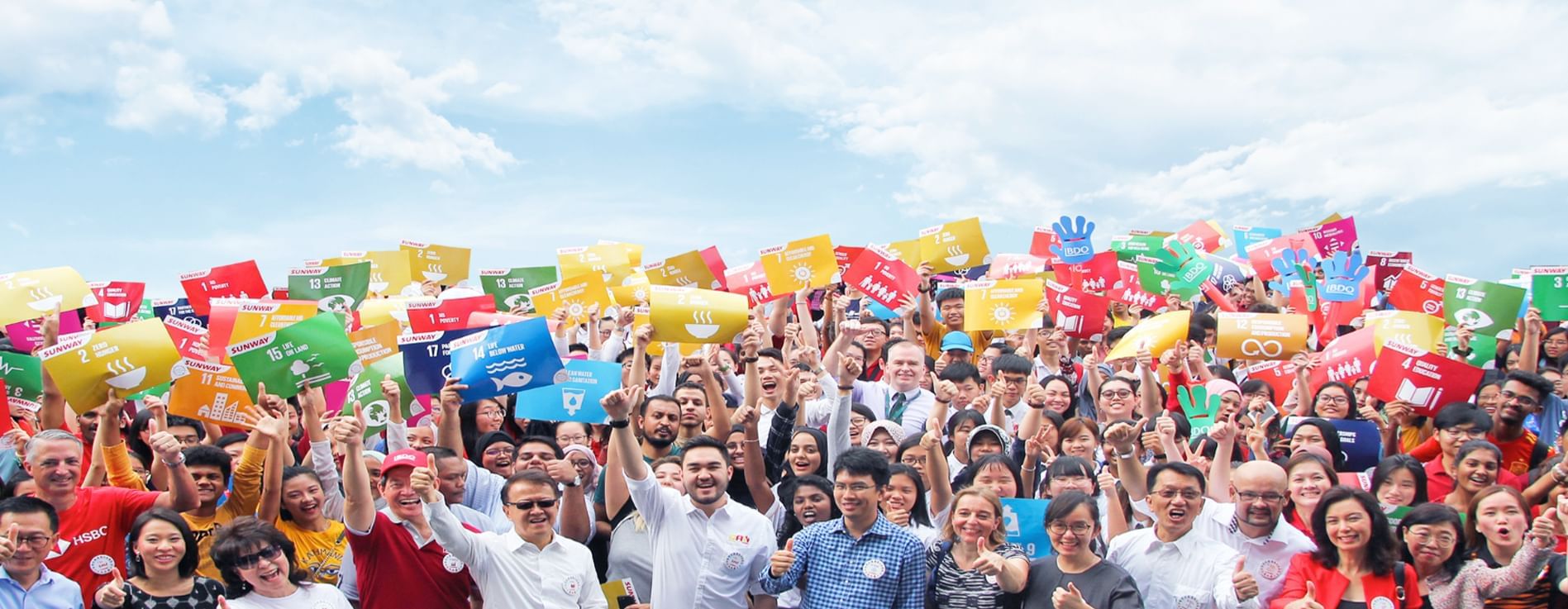 Staff posing with boards showing Sunway Lagoon's sustainability