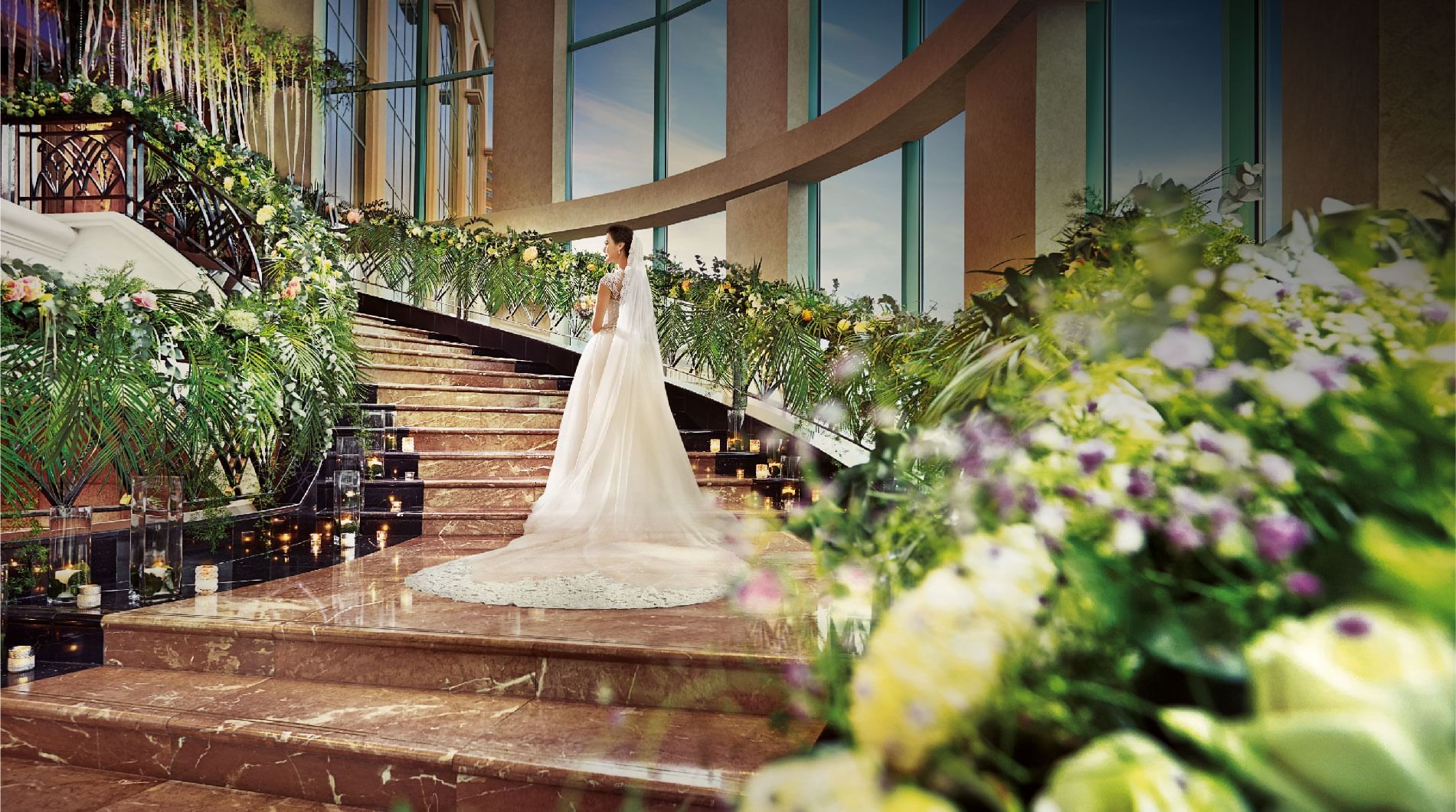 Bride in a white gown on marble stairs at Sunway Resort