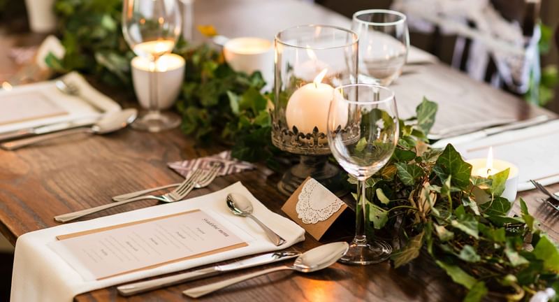 Close-up of a wedding table arrangement with flowers & candles at The Banjaran Hotsprings Retreat
