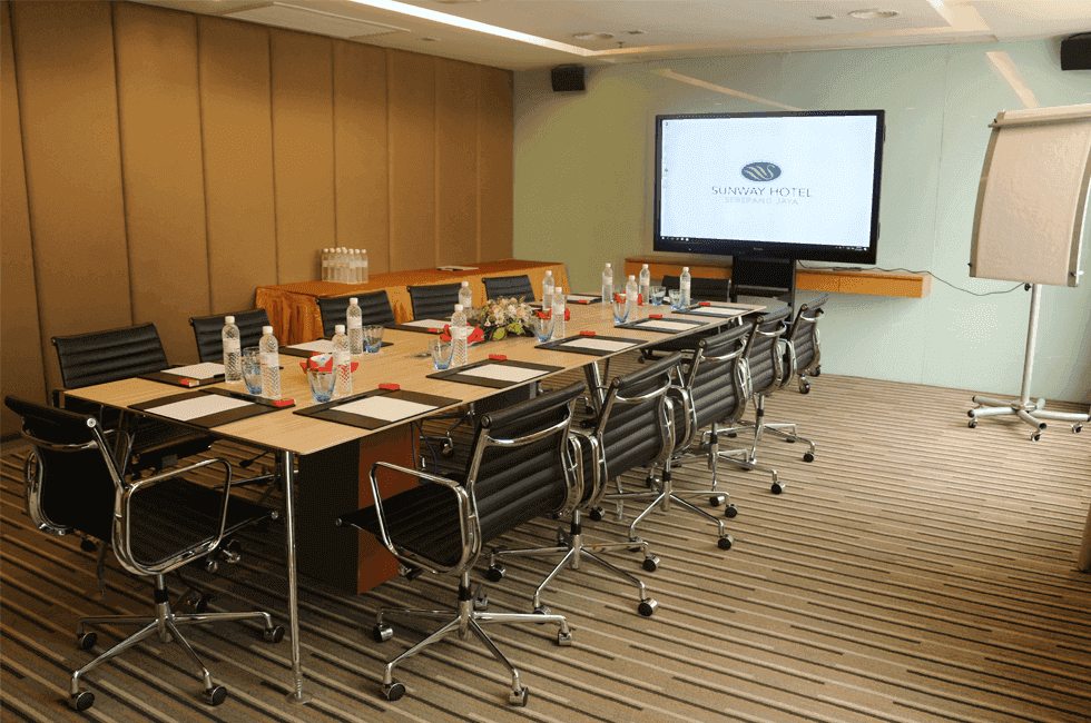 Boardroom meeting room arranged with a TV and chairs at Sunway Hotel Seberang Jaya