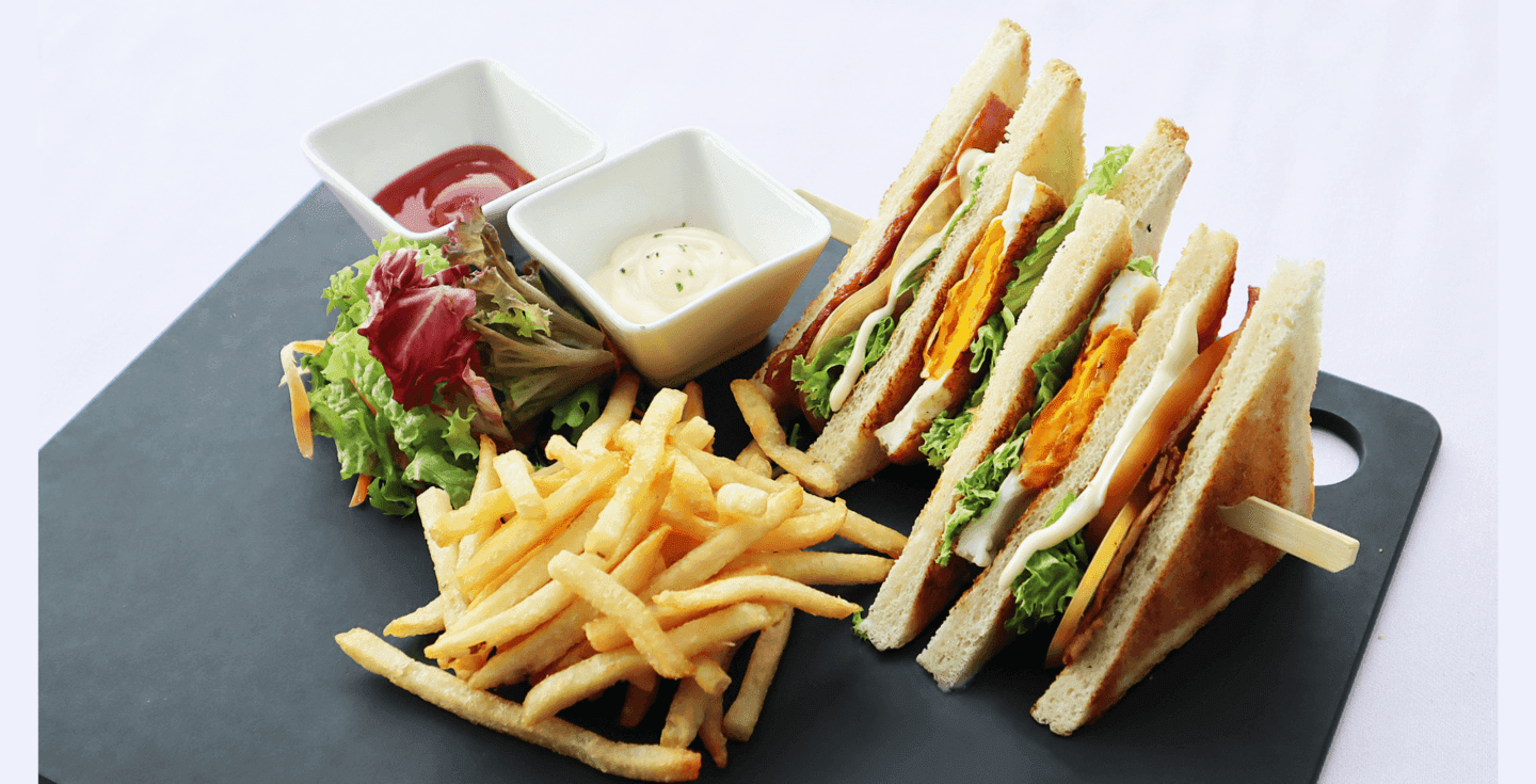 Club sandwich served with fries on a table at Sunway Hotel Big Box