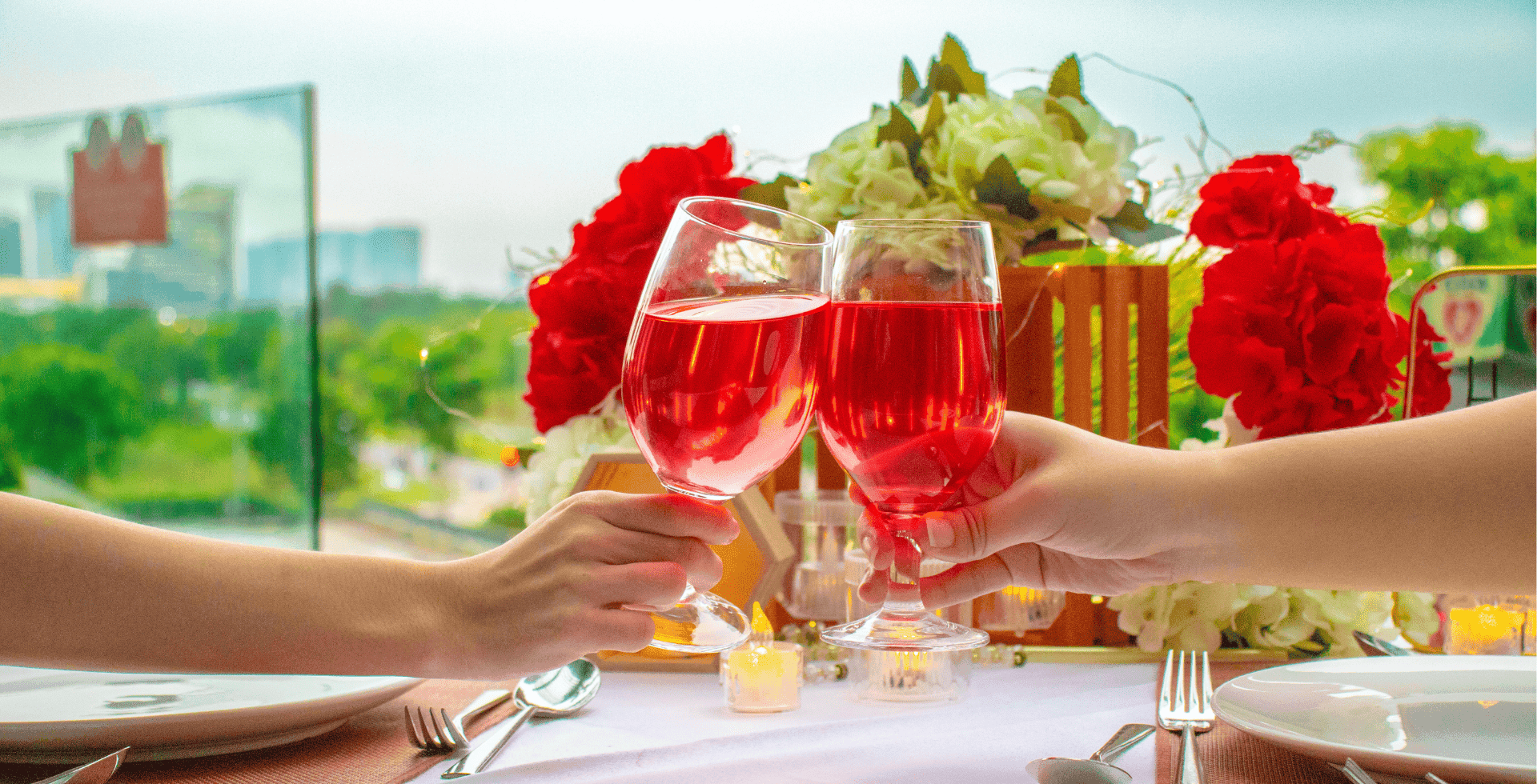 A couple toasting red wine glasses in a restaurant at Sunway Hotel Big Box